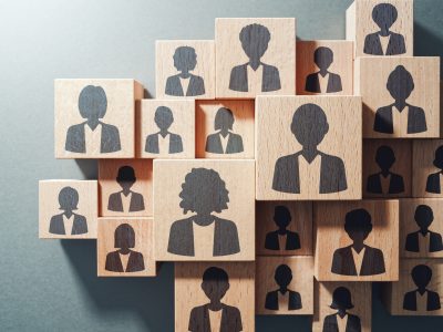 Team work and human resource management concept. Top view of various wood cubes with people icons.