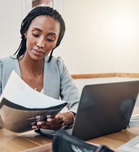 Black woman with business documents, small business entrepreneur working on strategy and planning online marketing. Learning startup industry vision, laptop for advertising company and technology job Black woman with business documents, small business entrepreneur working on strategy and planning online marketing. Learning startup industry vision, laptop for advertising company and technology job