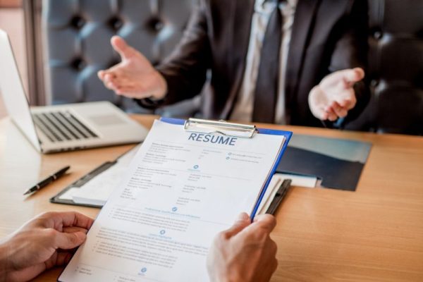 Job interview concept , Senior manager reading a resume during a job interview employee young man meeting Applicant and recruitment